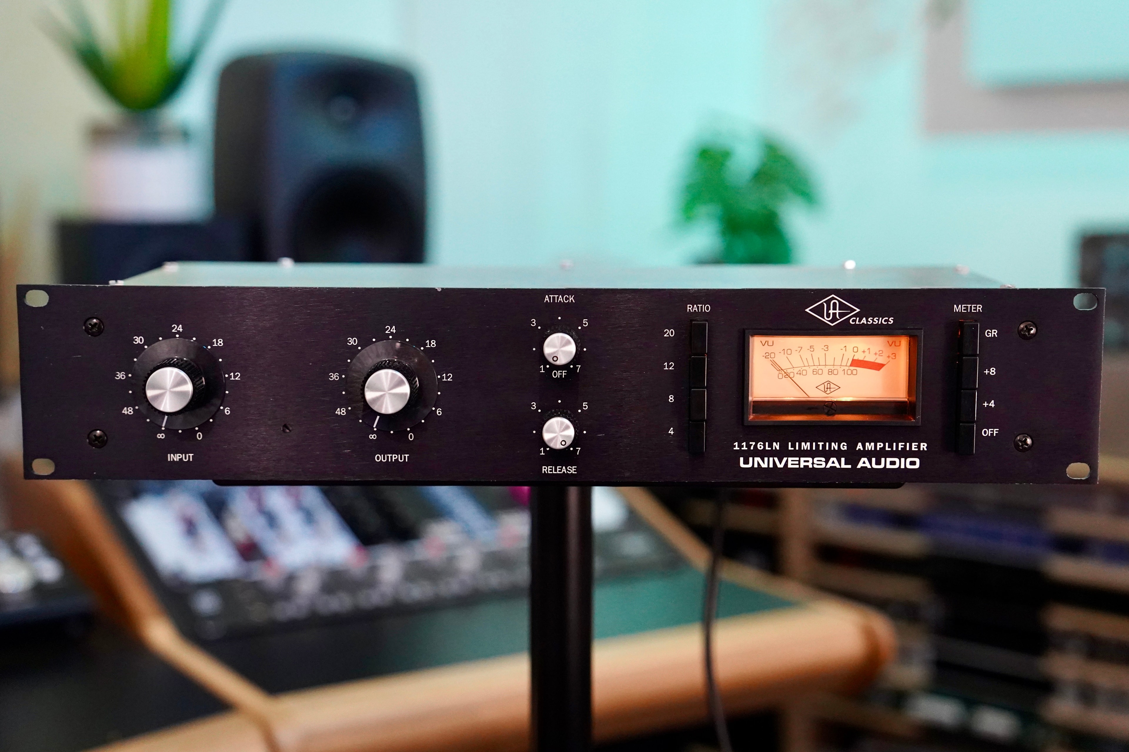 The silver input knob and white decibel scale of a Universal Audio 1176LN compressor